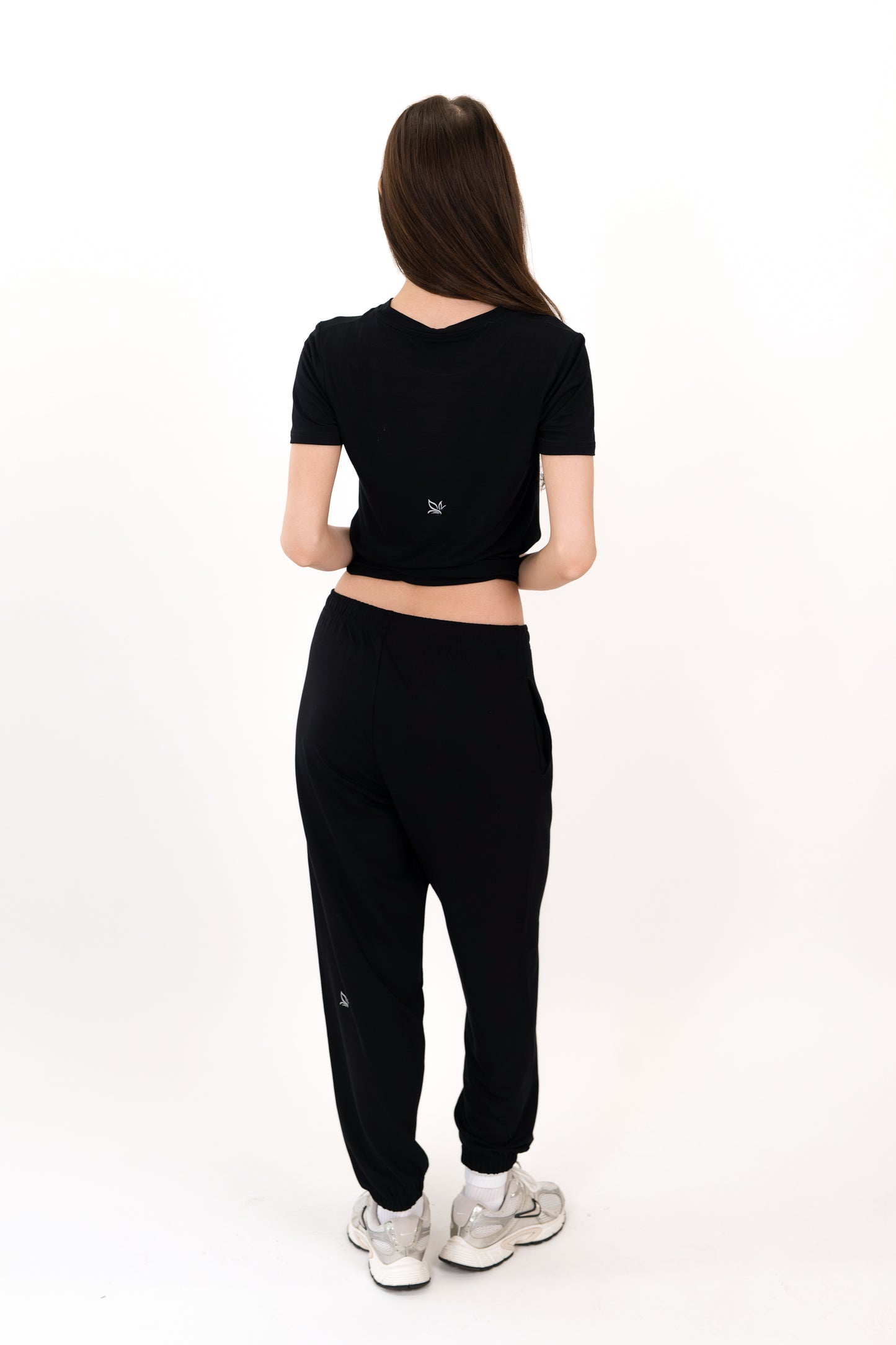 Model wearing The Solace Sweatpant in Onyx by ON/OFF Essentials, made from 95% bamboo fleece.