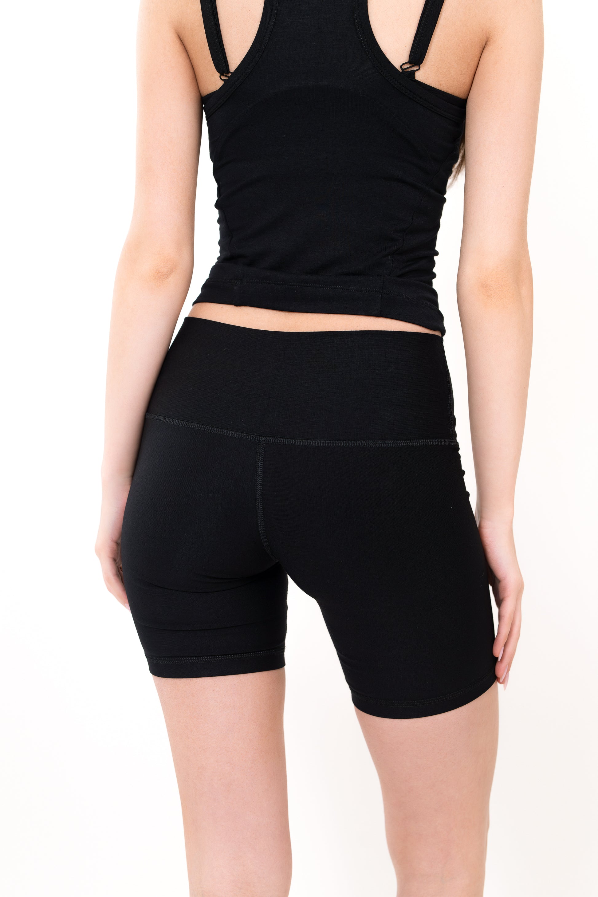 Model wearing The Core Short 5” in Onyx by ON/OFF Essentials, made from 95% bamboo.
