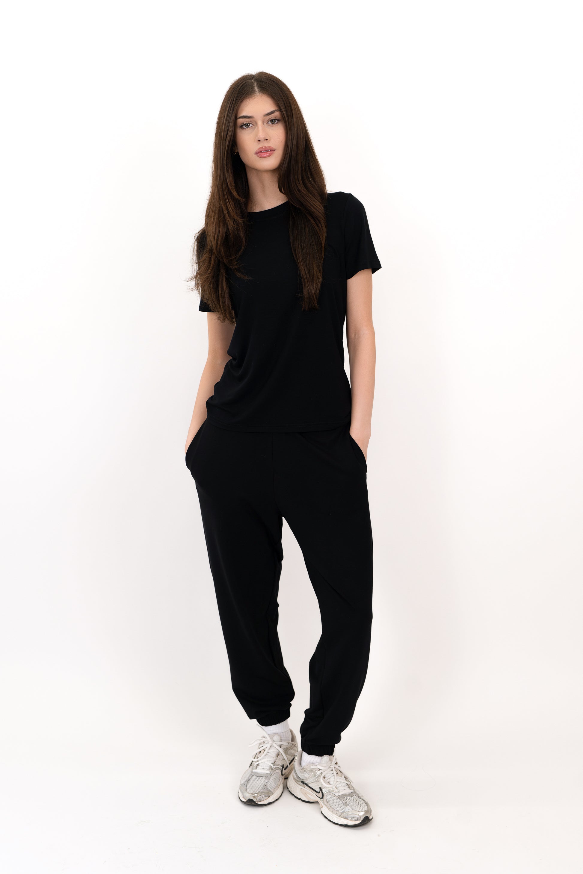 Model wearing The Solace Sweatpant in Onyx by ON/OFF Essentials, made from 95% bamboo fleece.