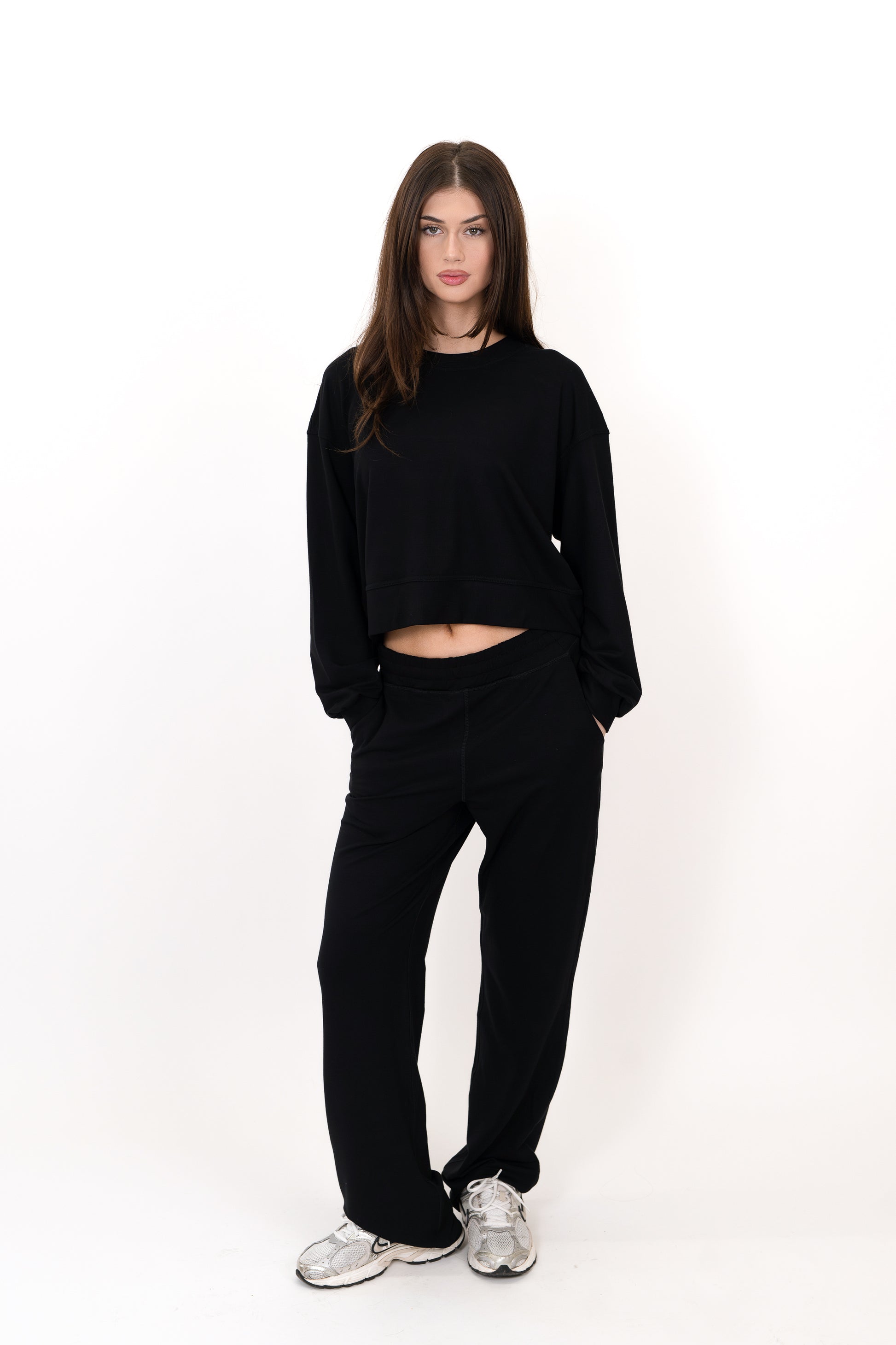 Model wearing The Solace Wide Leg Sweatpant in Onyx by ON/OFF Essentials, made from 95% bamboo fleece.