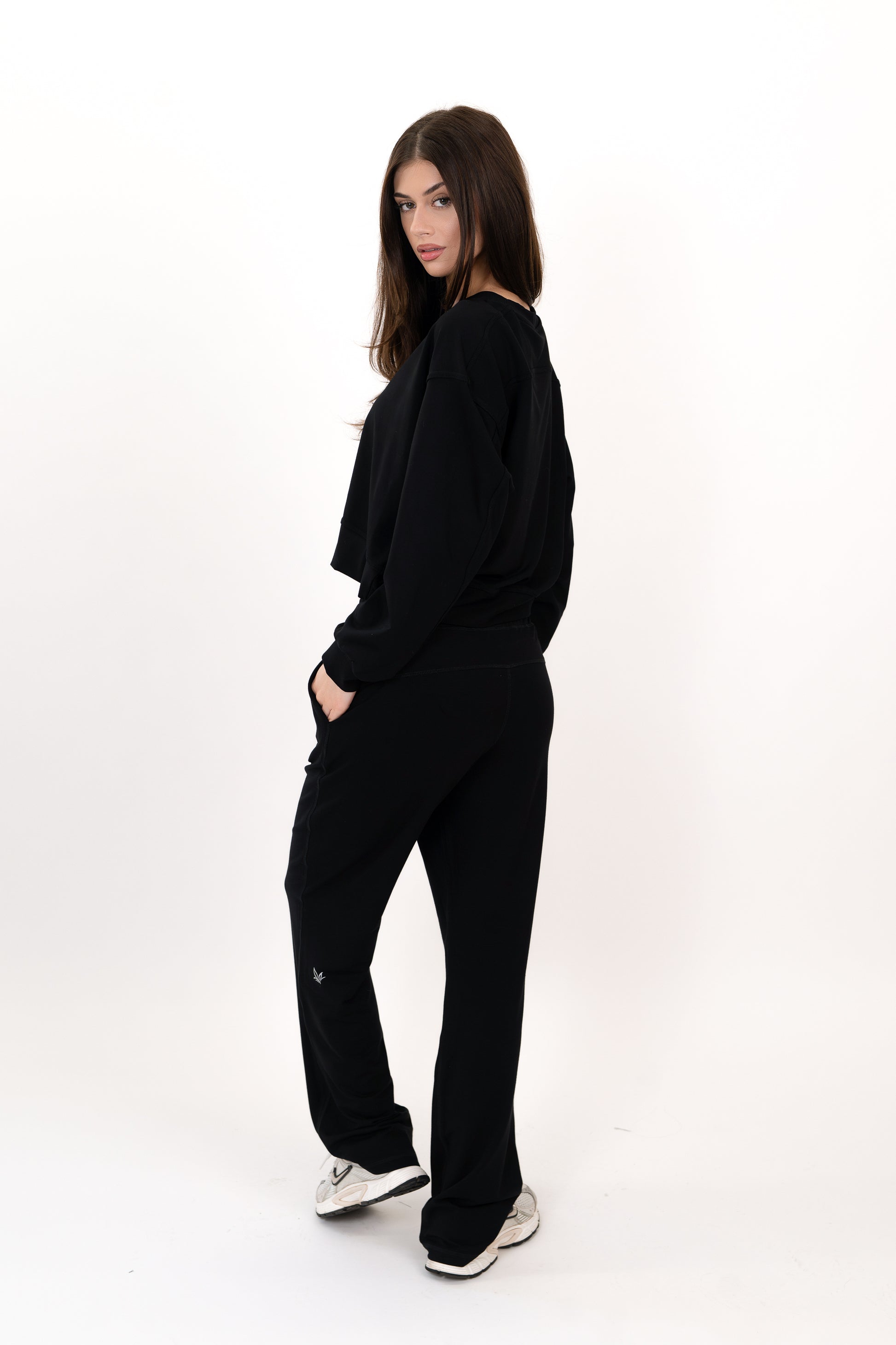 Model wearing The Solace Wide Leg Sweatpant in Onyx by ON/OFF Essentials, made from 95% bamboo fleece.