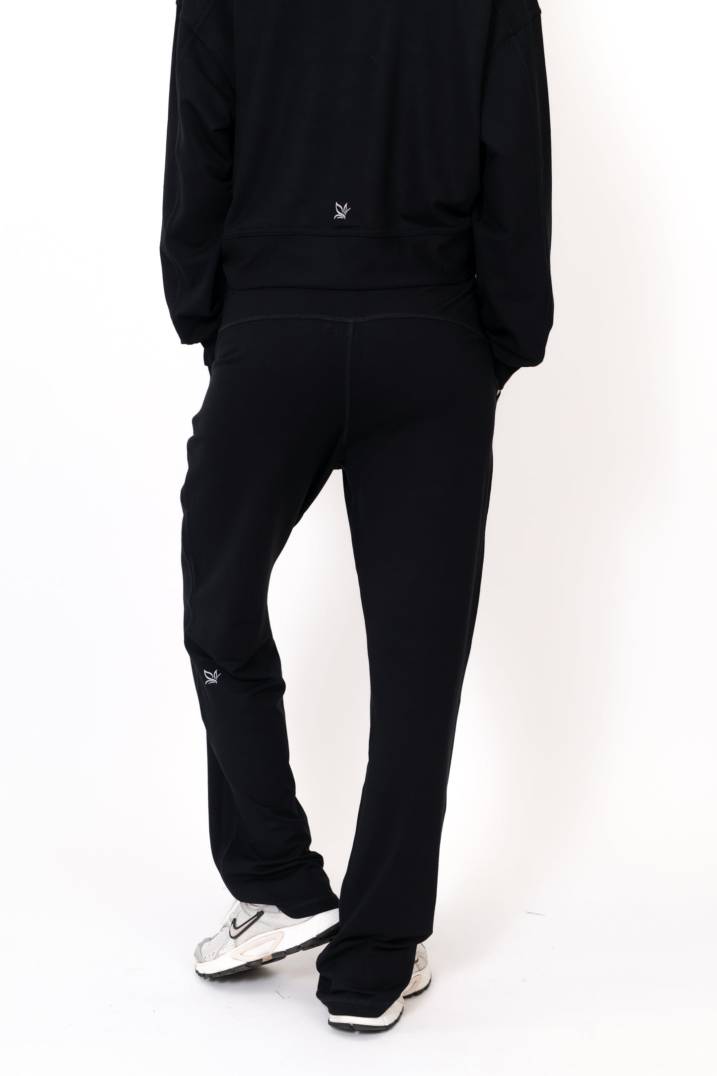 Model wearing The Solace Wide Leg Sweatpant in Onyx by ON/OFF Essentials, made from 95% bamboo fleece.