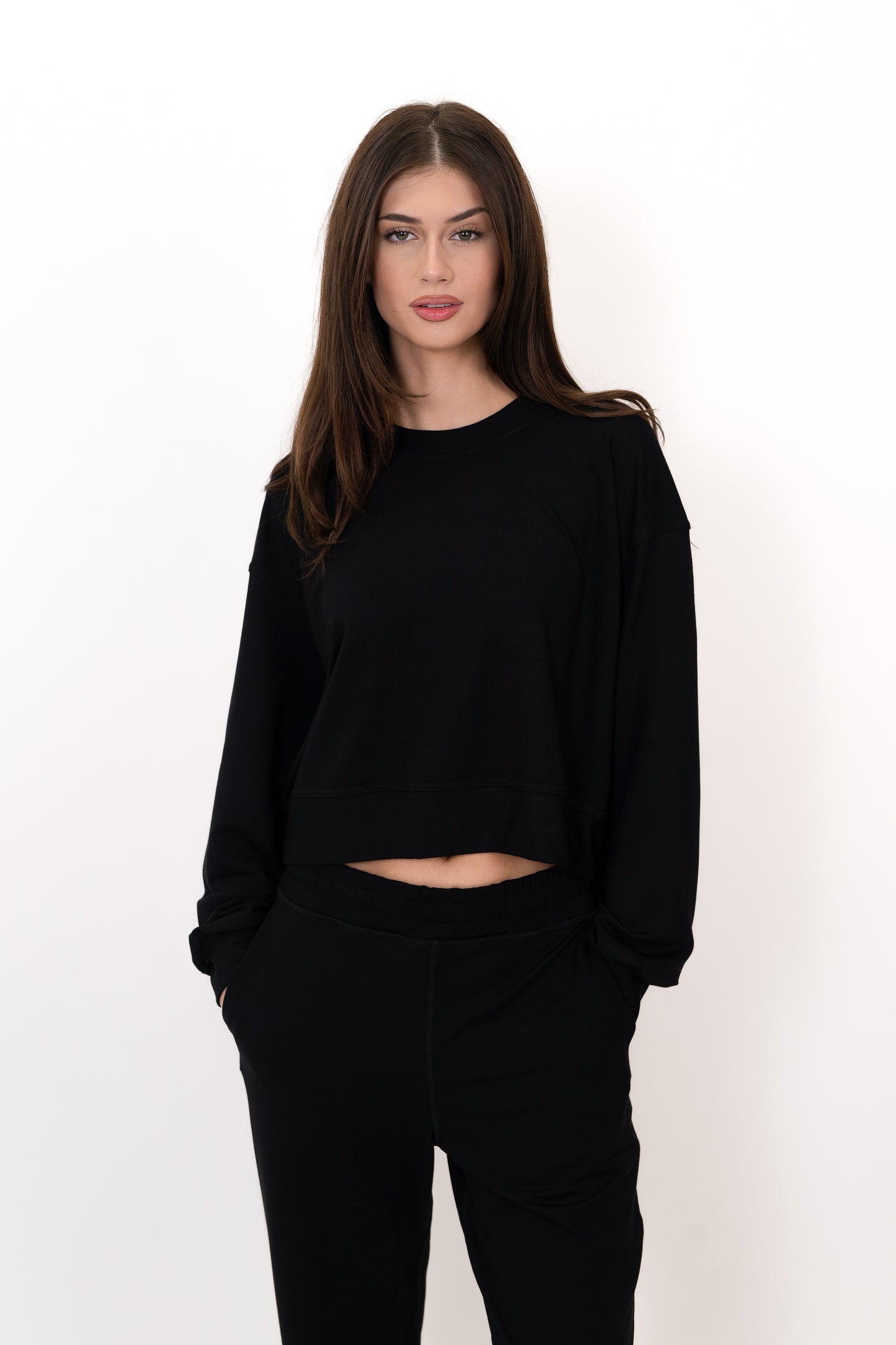 Model wearing The Solace Crew Neck in Onyx by ON/OFF Essentials, made from 95% bamboo fleece.