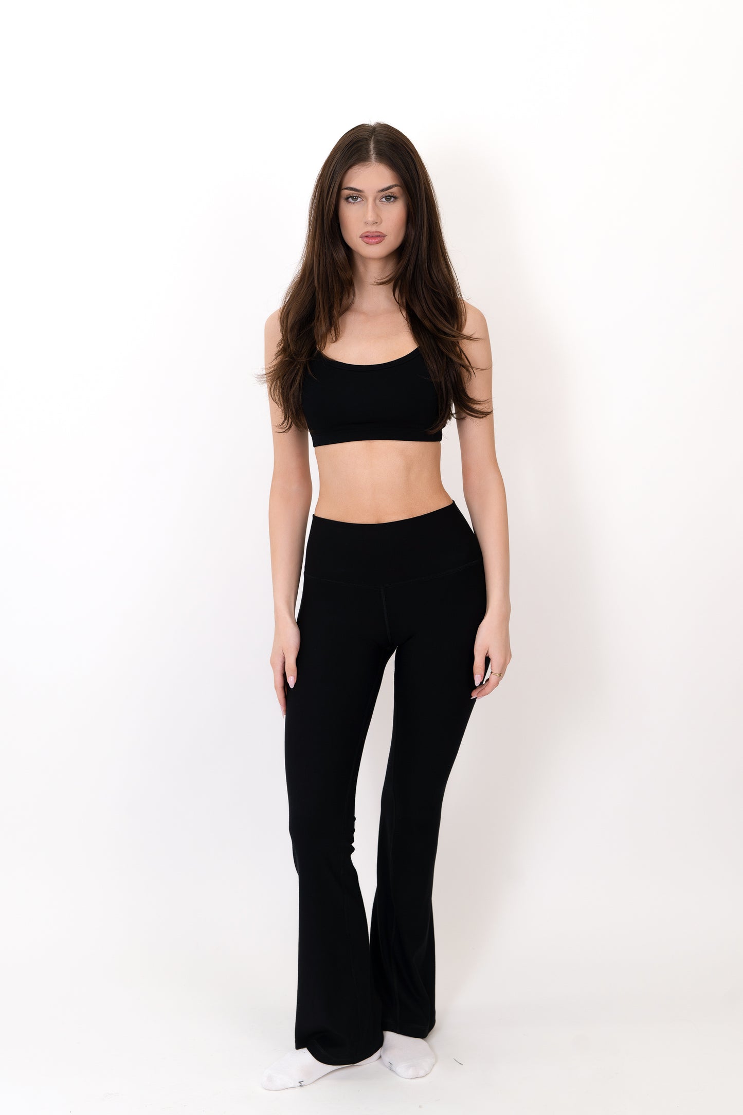 Model wearing The Core Flare Legging in Onyx by ON/OFF Essentials, made from 95% bamboo.