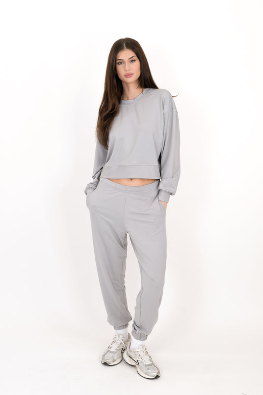 Model wearing The Solace Sweatpant in Fog by ON/OFF Essentials, made from 95% bamboo fleece.