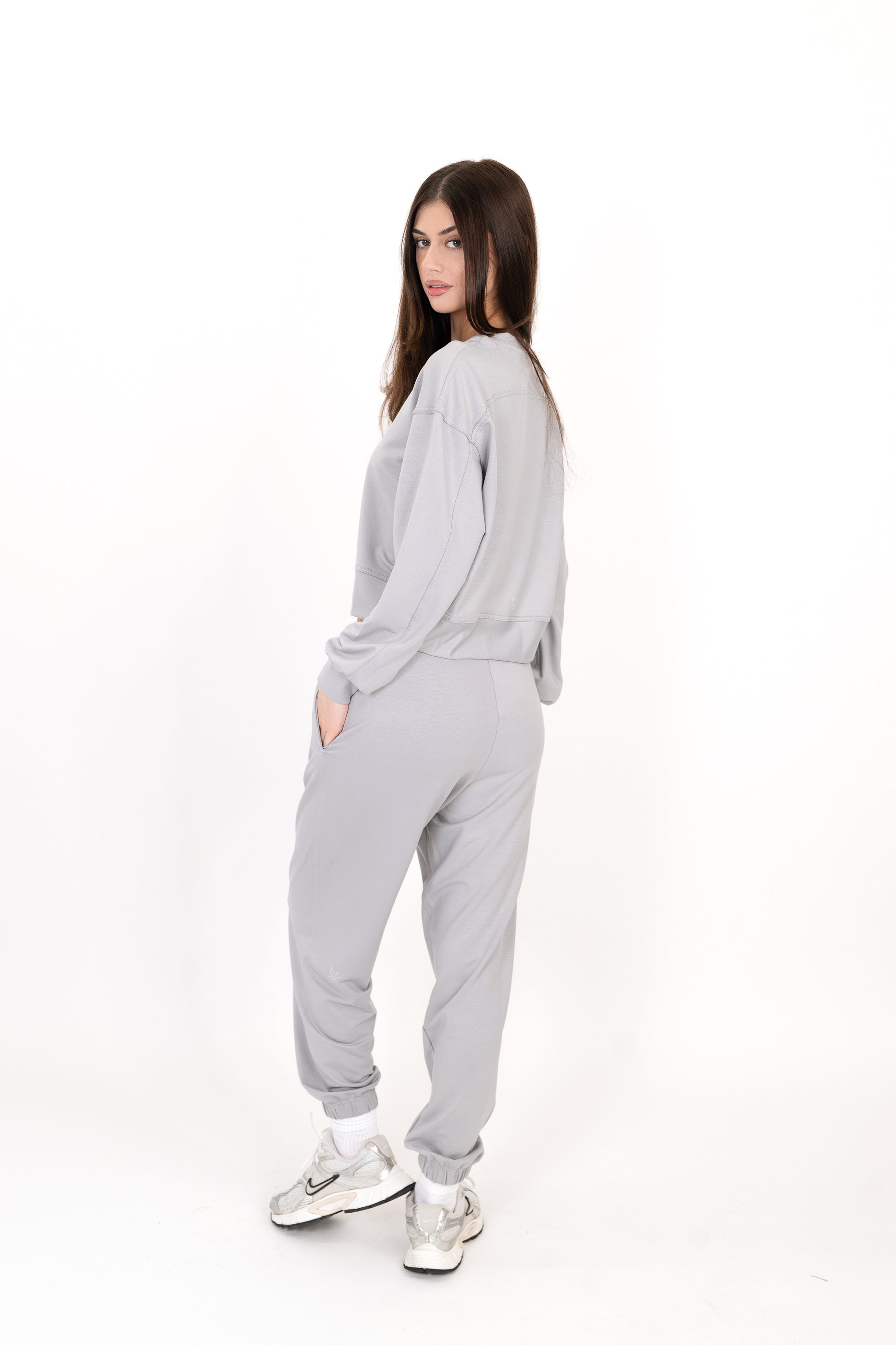 Model wearing The Solace Sweatpant in Fog by ON/OFF Essentials, made from 95% bamboo fleece.