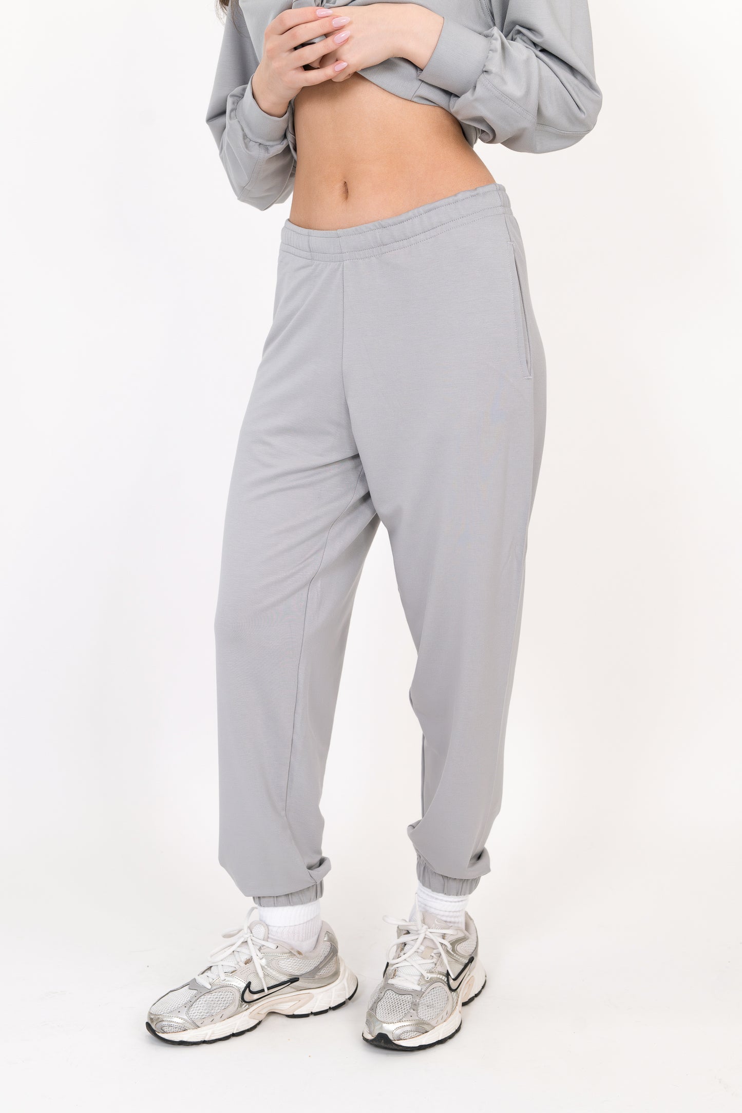 Model wearing The Solace Sweatpant in Fog by ON/OFF Essentials, made from 95% bamboo fleece.