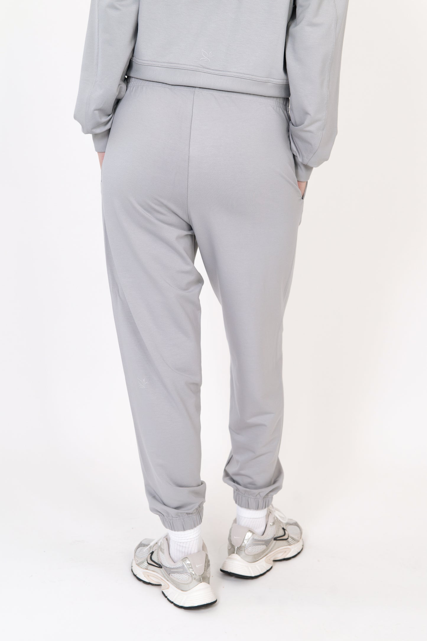 Model wearing The Solace Sweatpant in Fog by ON/OFF Essentials, made from 95% bamboo fleece.